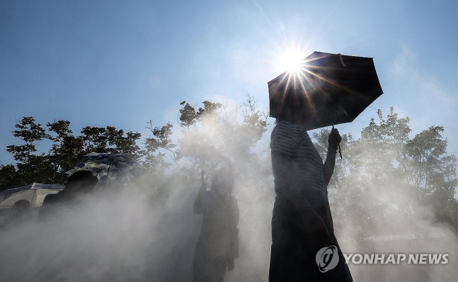 Coping with the heat using cooling fog and parasols
(Daegu=Yonhap News) Reporter Yun Gwan-sik = Citizens in Daegu are seen using parasols and cooling fog installed near Kim Kwang-seok Dasi Guri-gil in Daegu's Jung District. A heat wave advisory is in effect in Daegu. June 18, 2024 psik@yna.co.kr