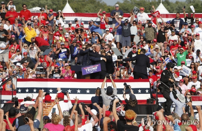 USA TRUMP RALLY
epa11476799 Former US President Donald Trump pumps his fist as he is rushed from stage by secret service