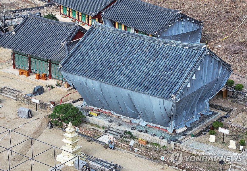 '아직 잔불 남았다'…여전히 방염포 두른 대전사 (청송=연합뉴스) 윤관식 기자 = 지난 29일 경북 청송군 대전사의 보광전 등 건물이 주불 진화 후에도 방염포를 두르고 있다.2025.3.30.