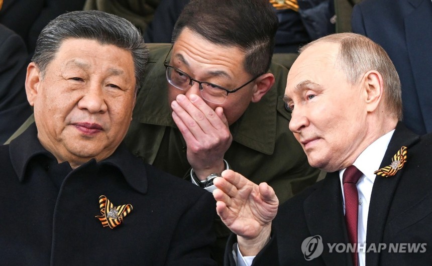 러시아 전승절 열병식 지켜보며 대화하는 중국·러시아 정상들 [UPI 연합뉴스 자료사진.재판매 및 DB 금지]
