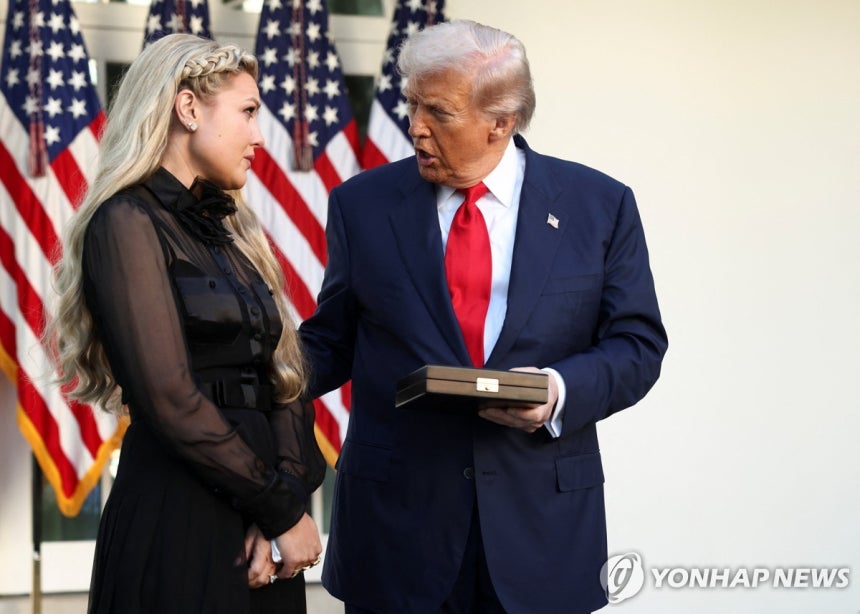 President Trump Converses with Kirk's Wife