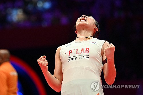 An Se-young of South Korea celebrates after defeating Wang Zhiyi of China in the women's singles fin