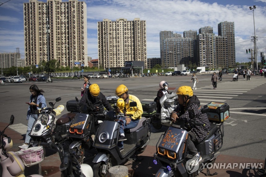 Food delivery workers in Beijing, China [EPA Yonhap News File Photo. No resale or database storage]