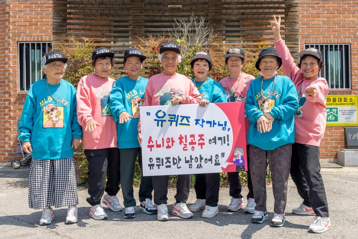 [칠곡=뉴시스] 수니와칠공주 할머니들이 지난 6일 tvN '유퀴즈 온 더 블럭' 출연을 바라는 손글씨 푯말을 들고 제작진에게 공개 러브콜을 보내고 있다.(사진=칠곡군 제공) 2025.05.07 photo@newsi