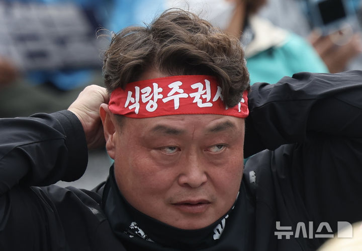 [서울=뉴시스] 김명년 기자 = 10일 오후 서울 종로구 경복궁 동십자각 인근에서 열린 '전봉준투쟁단 내란농정 청산 농업대개혁 범시민대회'에서 농민이 머리띠를 두르고 있다.2025.05.10.kmn@newsis.