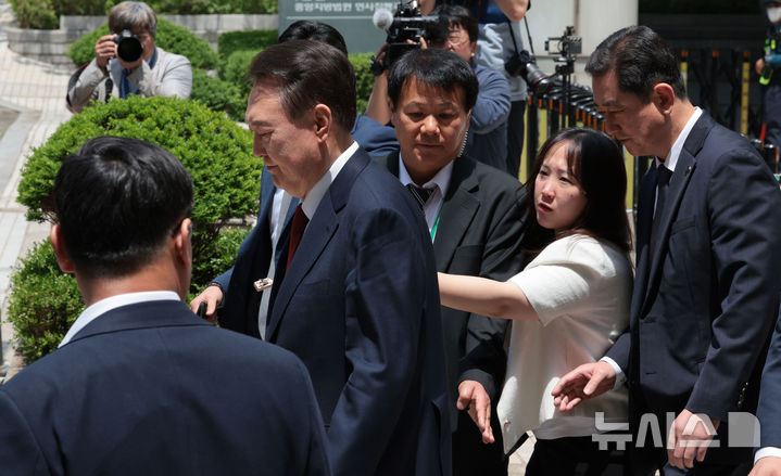 [서울=뉴시스] 사진공동취재단 = 윤석열 전 대통령이 26일 서울 서초구 서울중앙지방법원에서 열린 내란 우두머리 혐의·직권남용 권리행사 방해 혐의 사건 5차 오전 공판을 마친 뒤 차량으로 향하고 있다. 2025.05