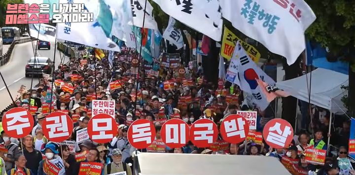 [서울=뉴시스]진보단체 촛불행동과 한국대학생진보연합(대진연) 회원 8명 등이 9일 오후 서울 광화문역 7번 출구 앞에서 '109차 전국집중 촛불대행진'을 열고 있다.(사진=촛불행동 유튜브 캡처) 2026.05.09