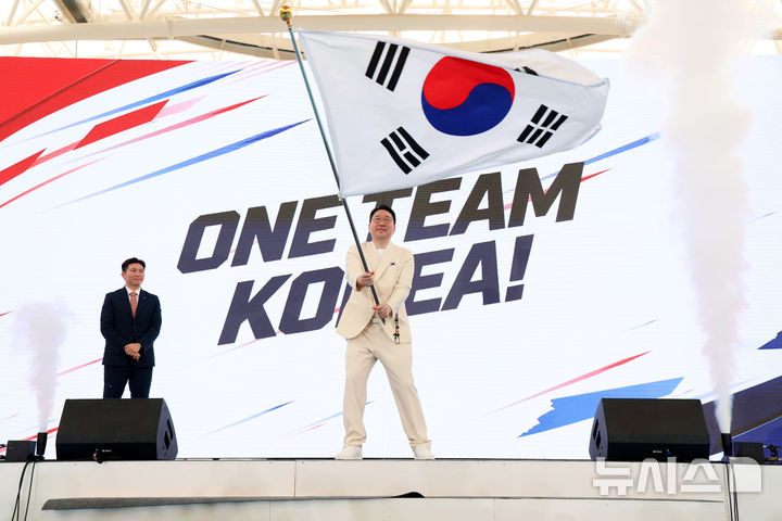 [진천=뉴시스] 이영환 기자 = 이상현 선수단장이 3일 오후 충북 진천국가대표선수촌 벨로드롬에서 열린 2026 아이치-나고야 하계아시아경기대회 대한민국 선수단 결단식에서 단기를 흔들고 있다. 2026.09.03. 2