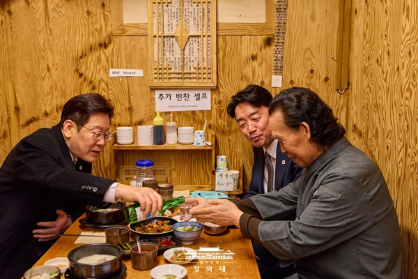 ▲ 이재명 대통령이 지난 9일 서울 종로구 통인시장의 한 식당을 방문해 상인과 소주를 마시며 대화하고 있다. 사진=청와대