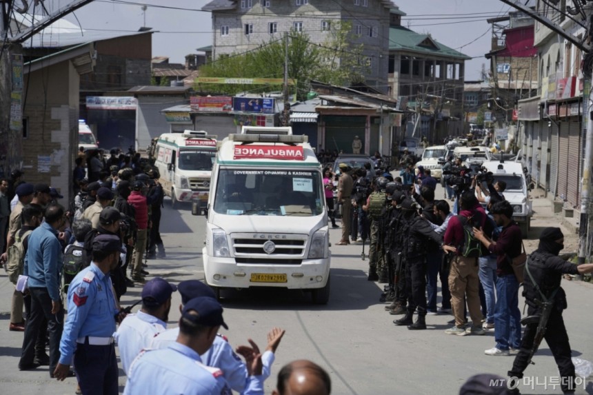 Police guard as ambulances carry bodies of tourists,in Srinagar,Indian controlled Kashmir,Wednesday,April.23,2025.
