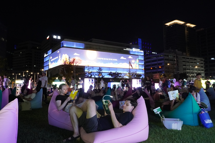 Foreigners reading books at Seoul Outdoor Library in Gwanghwamun, Seoul. <Photo provided by Seoul City>