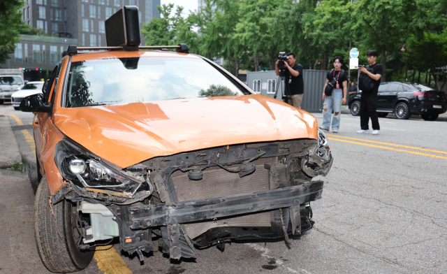 3일 서울 중구 국립중앙의료원에 택시가 돌진하는 사고가 발생했다. 취재진들이 사고 차량을 촬영하고 있다. 연합뉴스