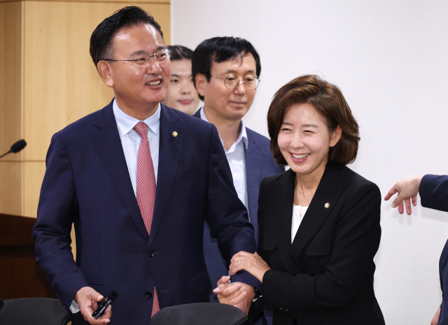 Na Kyung-won (right), a member of the People's Power Party, is greeting fellow party member Yoo Sang-beom during a seminar on 'Wages of Filipino housekeepers, issues and solutions' held at the National Assembly Members' Office Building on the morning of August 27. Yonhap News