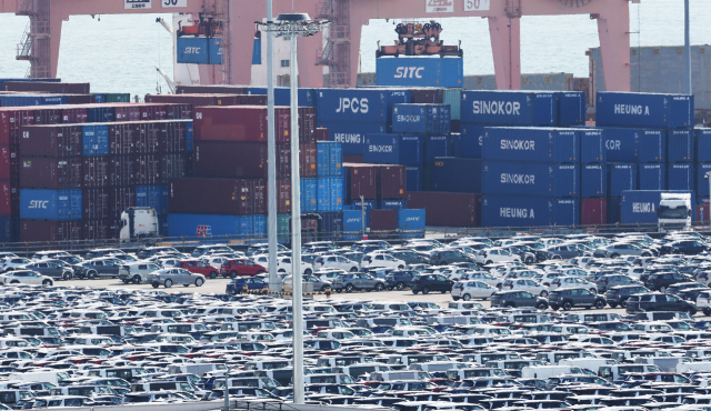 16일 경기도 평택항에 수출 대기 중인 자동차 뒤로 컨테이너가 쌓여 있는 모습. 연합뉴스