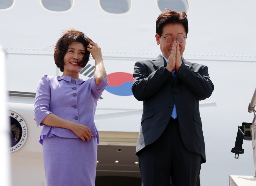 인도 국빈방문을 마치고 베트남으로 향하는 이재명 대통령과 김혜경 여사가 21일(현지시간) 뉴델리 팔람 공군기지 공군 1호기에 탑승하며 환송객에게 인사하고 있다. 연합뉴스