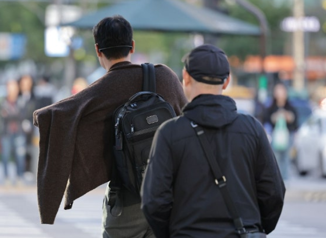 서울 종로구 광화문광장에서 한 시민이 외투를 입고 있다.연합뉴스