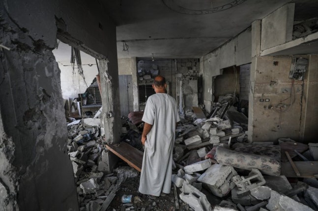 A Palestinian resident in the Al-Nusayrat refugee camp in Gaza looks inside a destroyed house hit by an Israeli airstrike on the 6th (local time). Hamas has temporarily set aside its demand for a permanent ceasefire, agreed to a temporary ceasefire with Israel, and plans to resume negotiations for a longer-term truce after this period.