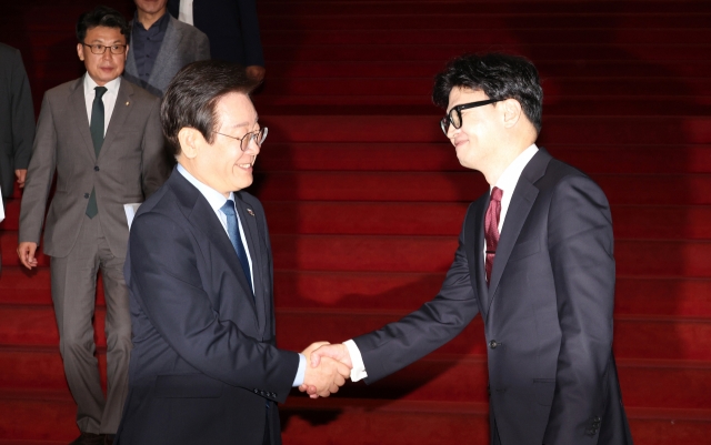 Hahn Dong-hoon (right), the leader of the People Power Party, and Lee Jae-myung (left), the leader of the Democratic Party, are greeting each other after the meeting of party leaders at the National Assembly on the afternoon of the 1st. [Yonhap]