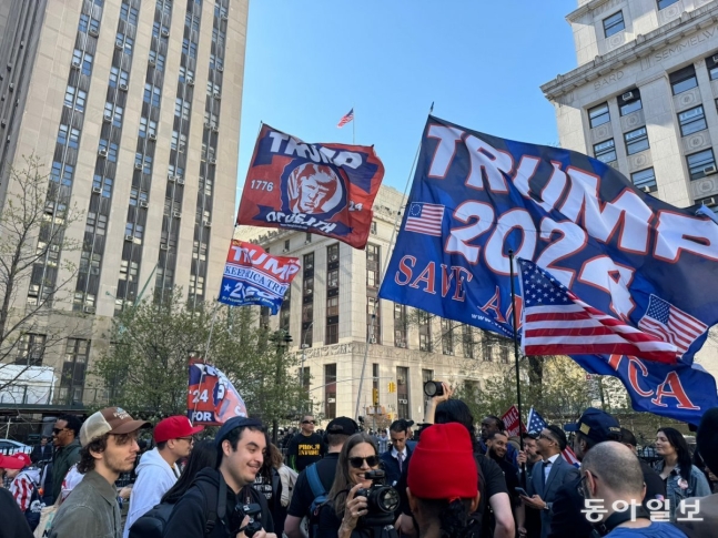 15일(현지 시간) 미국 뉴욕 맨해튼지방법원 앞에서 도널드 트럼프 전 대통령의 지지자 수십여 명이 깃발을 흔들며 트럼프 전 대통령을 연호하고 있다. 뉴욕=김현수 특파원 kimhs@donga.com
