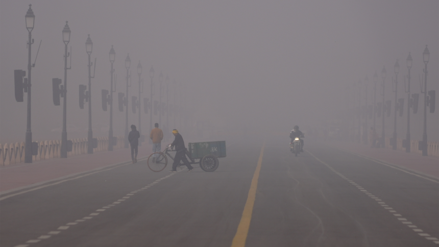 스모그로 뒤덮인 인도 뉴델리의 아침에 한 남성이 자전거 수레를 밀고 가고 있다.AP/뉴시스