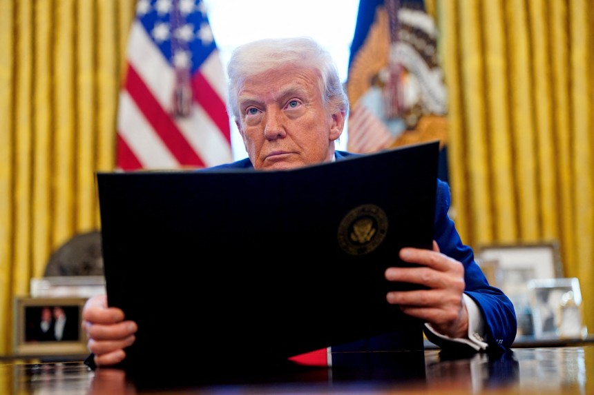 U.S. President Donald Trump looks on, as he signs executive orders and proclamations in the Oval Office at the White Ho
