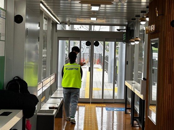 11일 낮 12시 제주시 명신마을 BRT 정류장에서 양문형버스를 기다리는 시민과 교통안내 도우미.최충일 기자