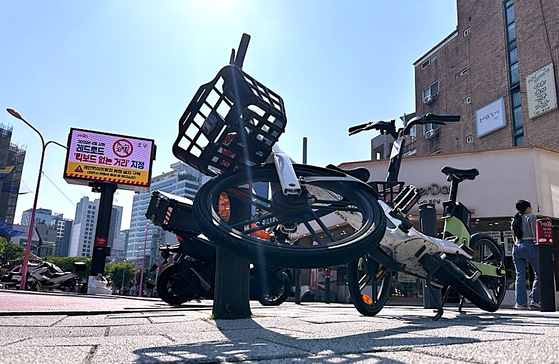 서울 마포구 어울마당로 '홍대 레드로드'에 개인형 이동장치가 보행자들의 통행을 가로막은 채 넘어져있다.전광판에는 마포구청이 이 곳을 '킥보드 없는 거리'로 지정했다는 안내문을 송출하고 있다.문희철 기자