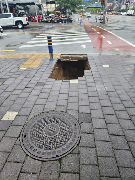 지난 21일 오후 6시 12분쯤 전북 남원시 도통동 한 교차로 인근 횡단보도 앞 인도에서 발생한 '땅 꺼짐(싱크홀)' 사고로 생긴 구멍. 사고 직후 시민 도움으로 싱크홀에서 빠져 나온 박모(46)씨가 직접 찍었다. 