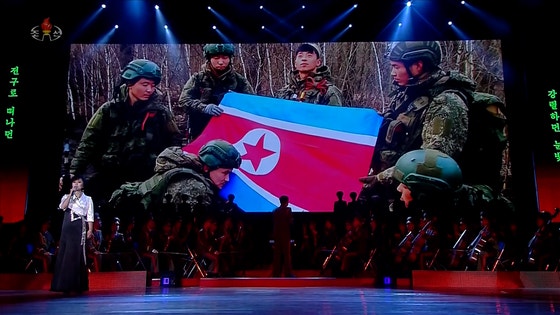 북한이 지난달 29일 평양 4.25문화회관에서 열린 공연에서 러시아 파병 북한 군인들의 활동 모습 사진을 비추고 있다. 조선중앙TV화면=연합뉴스