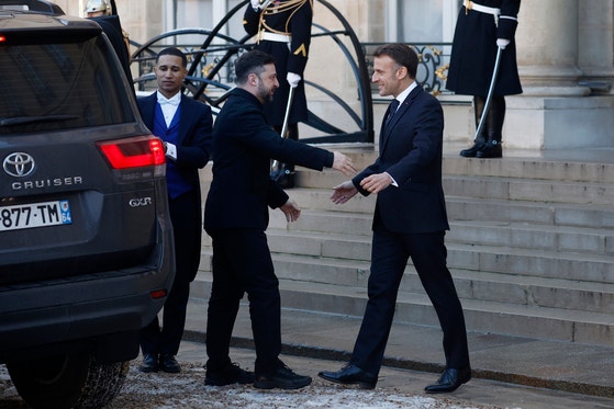 에마뉘엘 마크롱 프랑스 대통령(오른쪽)이 6일 파리 엘리제궁에 도착한 볼로디미르 젤렌스키 우크라이나 대통령(가운데)을 맞이하고 있다.EPA=연합뉴스