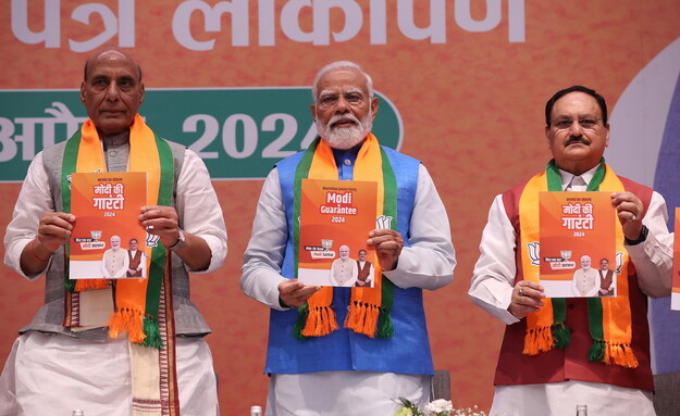 라지나트 싱 인도 국방장관(왼쪽부터), 나렌드라 모디 총리, 제이피 나다 인도인민당(BJP) 의장이 14일(현지시각) 뉴델리 인도인민당 당사에서 총선 공약집을 들어보이고 있다. EPA 연합뉴스