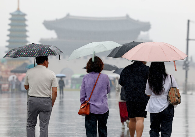 Citizens walking with umbrellas on a rainy Children's Day in Gwanghwamun Square, Seoul on May 5. Yonhap News