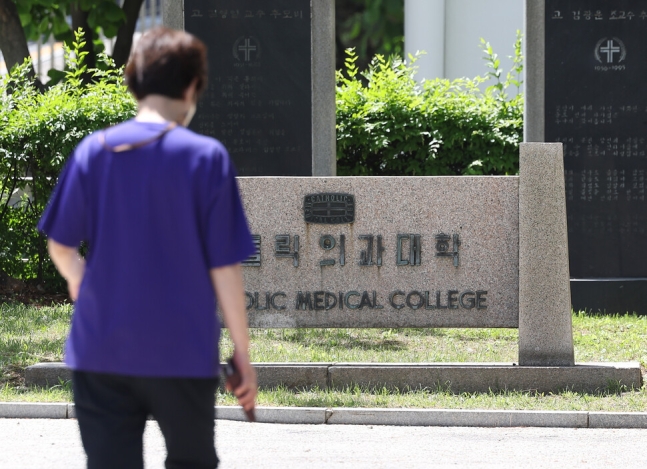 의정갈등이 이어지고 있는 12일 오전 한 시민이 서울 서초구 가톨릭의과대학 인근을 지나치고 있다. 연합뉴스