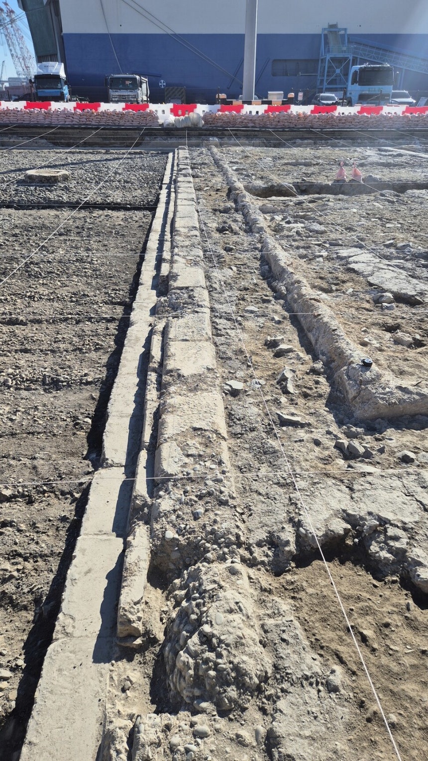 부산항 1부두 서쪽 옛 국제여객터미널 터의 발굴 조사 현장을 찍은 사진. 1910~1920년대 일제가 설치한 철도 역사의 기초 부분과 철도의 침목, 플랫폼 기단부 등이 보인다. 남쪽 부두 뒤에 대형 화물선이 정박한