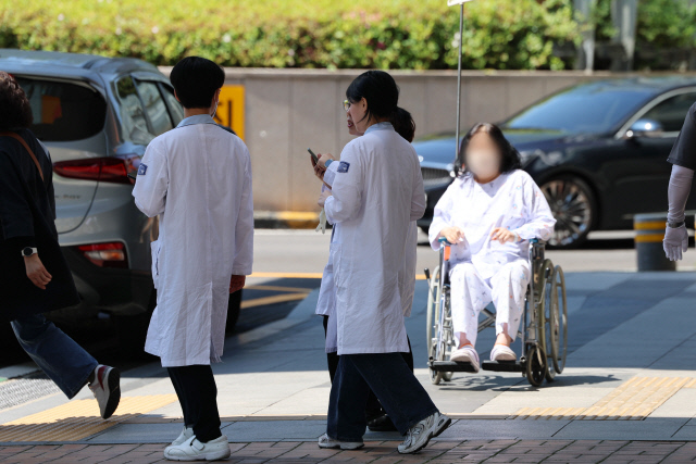 의대 정원 증원을 두고 의정갈등이 이어지는 가운데 8일 오전 서울 시내 한 대학병원에서 의료진이 이동하고 있다.  <연합뉴스>