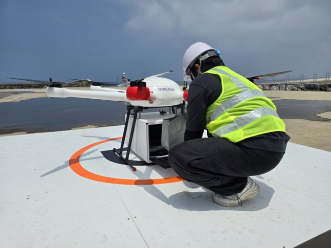A drone delivery company employee loading Samsung Electronics mobile products onto a drone at a drone delivery center located in Geumneung Port in Hanlim-eup, Jeju City.