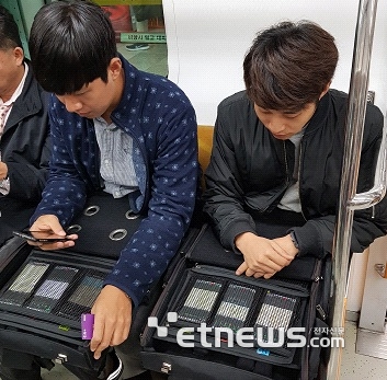 과기정통부 관계자들이 지하철에서 이동통신 속도를 측정하고 있다.