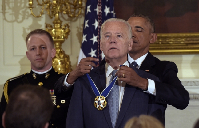 In January 2017, former US President Barack Obama (back row, right) is seen awarding the Presidential Medal of Freedom to then-Vice President Joe Biden (front) at the White House. AP News