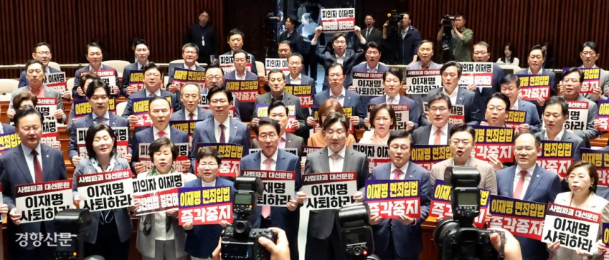 국민의힘 의원들이 7일 국회에서 열린 의원총회에서 더불어민주당의 형사소송법 및 공직선거법 개정안 추진을 규탄하는 손팻말을 들고 있다. 한수빈 기자 subinhann@kyunghyang.com