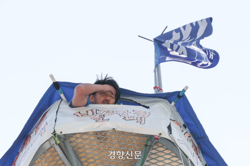 김형수 금속노조 거제통영고성조선하청지회장이 지난 12일 서울 중구 한화빌딩 앞 농성장을 방문한 국회 환경노동위원회 더불어민주당 소속 위원들과 전화통화를 하고 있다. 성동훈 기자