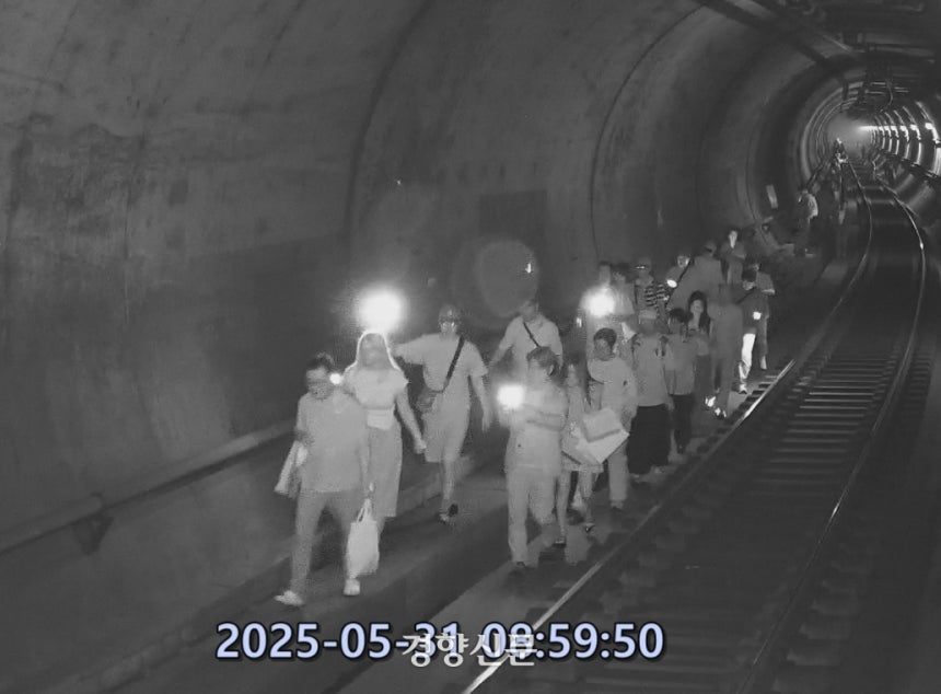 지난달 31일 오전 여의나루역에서 마포역 방향으로 달리던 지하철 5호선 열차에서 원모씨(67)가 붙인 불로 화재가 발생해 시민들이 선로를 따라 대피하는 모습. 서울남부지검 제공