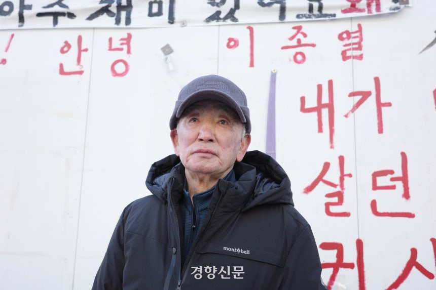 지난달 29일 서울 마포구 아현동의 한 도롯가에서 이종열씨(78)가 서 있다. 이씨의 뒤로 이씨가 붉은 글씨로 쓴 ‘안녕 이종열’이란 글자가 보인다. 우혜림 기자