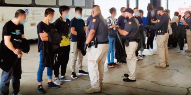 美國邊防警衛正在調查被捕的非法移民[美國海關邊境保護局]