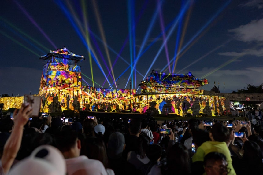 A media art installation at Hwaseomun Gate illuminates the gate and fortress walls during the 2026 Suwon Hwaseong Media 