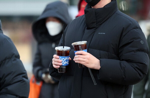 지난 12월 3일 서울 광화문 인근에서 한 시민이 추운 날씨에도 아이스 음료를 들고 이동하고 있다.photo 뉴스1
