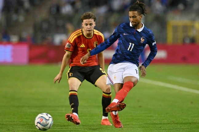 France's midfielder #11 Michael Olise (R) passes the ball in front of Belgium's defender #05 Maxim De Cuyper (L) during the UEFA Nations League Group A1 football match between Belgium and France at King Baudouin Stadium in Brussels on September 28, 2026. (Photo by NICOLAS TUCAT / AFP)