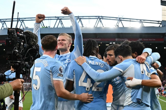 Manchester City's Norwegian striker #09 Erling Haaland celebrates with teammates after scoring the opening goal during the English Premier League football match between Liverpool and Manchester City at Anfield in Liverpool, north west England on October 11, 2026. (Photo by Paul ELLIS / AFP) / RESTRI