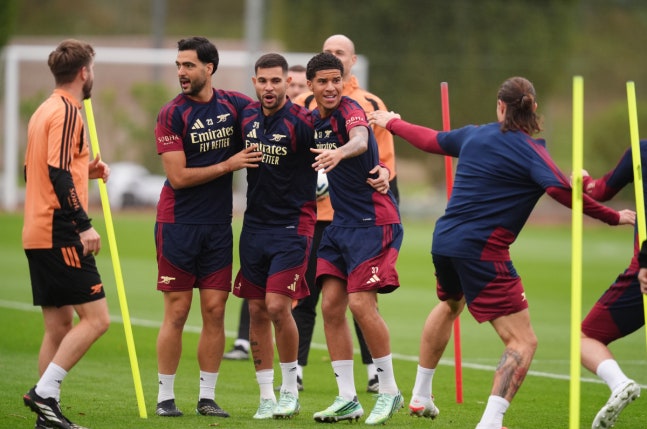 Arsenal's Mikel Merino (centre left), Bruno Guimaraes (centre) and Demiane Agustien (centre right) attend a training session at the Sobha Realty Training Centre, London, Monday Oct. 12, 2026. (John Walton/PA via AP)