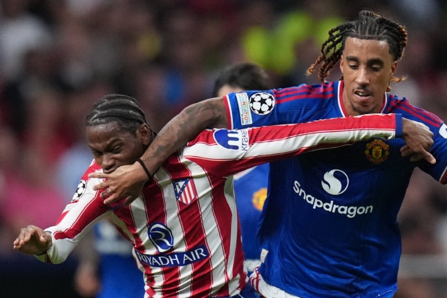 Manchester United's Leny Yoro, right, fouls Atletico Madrid's Jonathan David during the Champions League opening phase soccer match between Atletico Madrid and Manchester United in Madrid, Tuesday, Oct. 13, 2026. (AP Photo/Bernat Armangue)