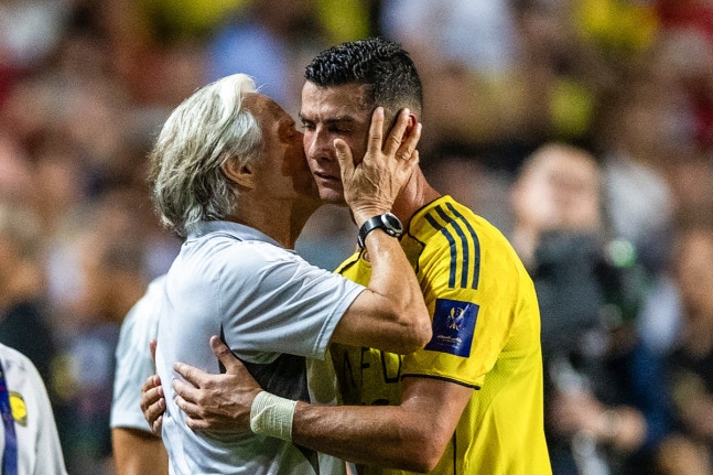 (FILES) Al-Nassr's head coach Jorge Jesus (L) embraces Cristiano Ronaldo as he gets substituted during the Saudi Super Cup semi-final football match between Al-Nassr and Al-Ittihad at the Hong Kong Stadium in Hong Kong on August 19, 2025. Portugal captain Cristiano Ronaldo announced on September 30 